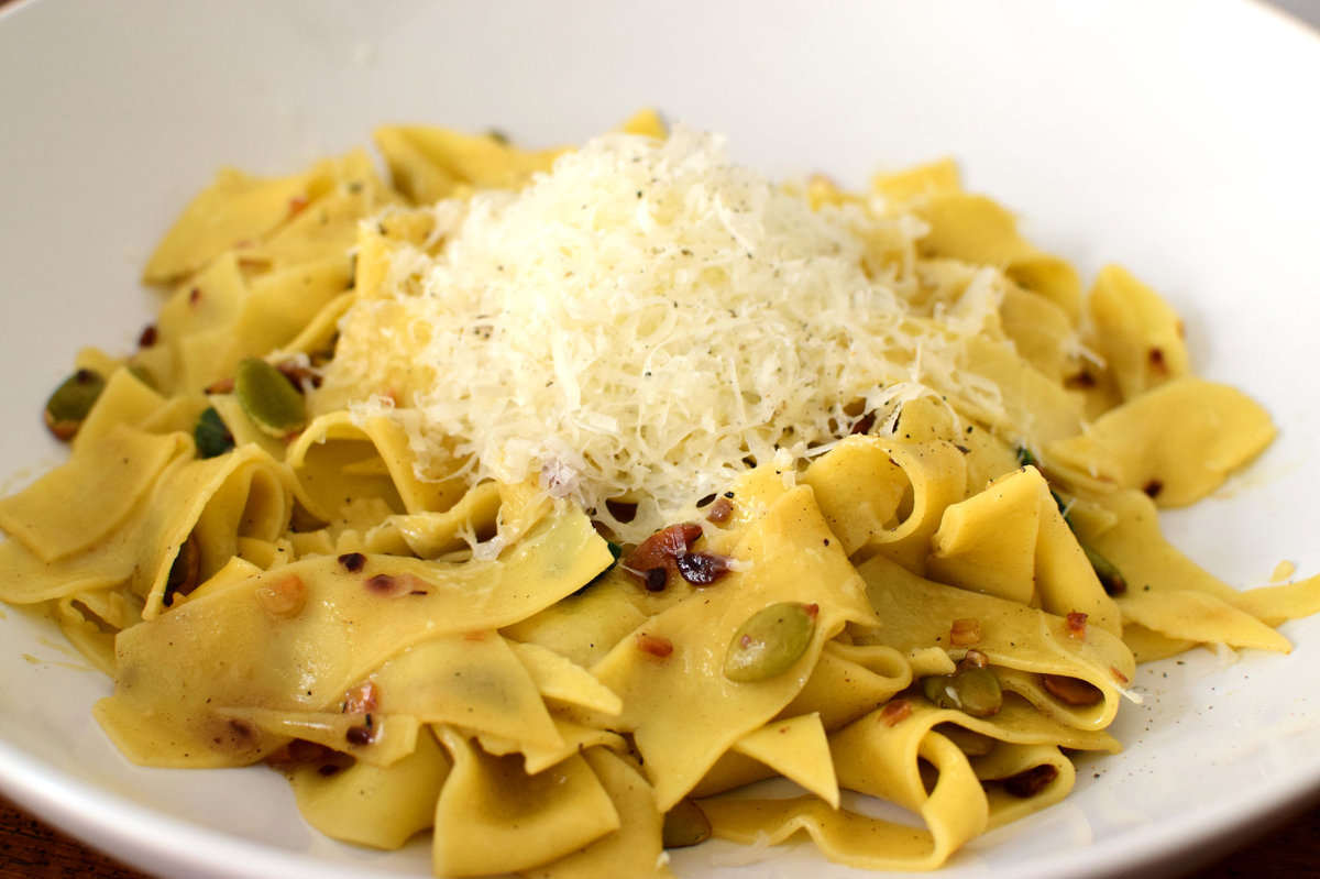 Pasta scraps with garlic, pumpkin seeds, and fresh sage.
